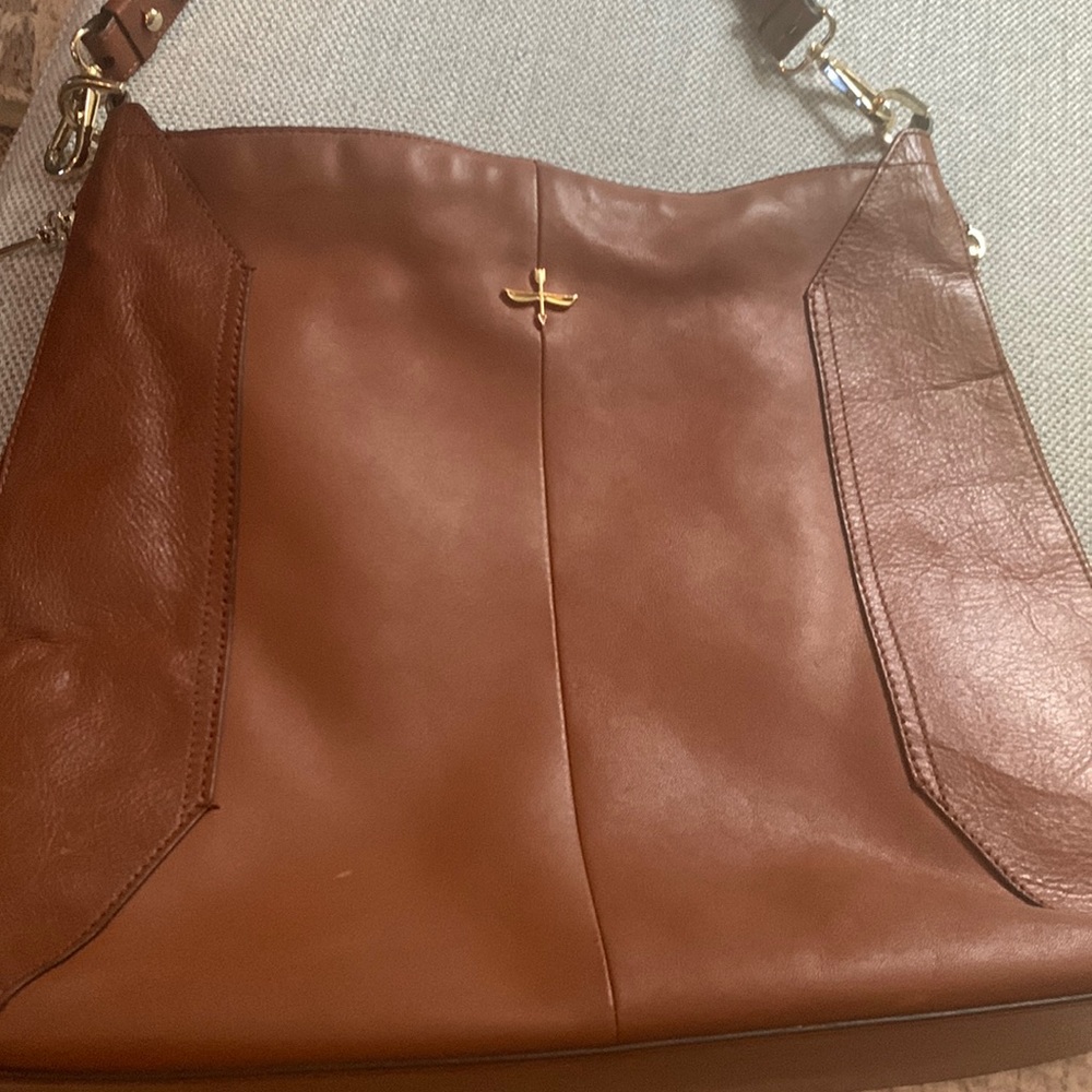 Pour La Victoire Saddle Brown side pockets leather bag.